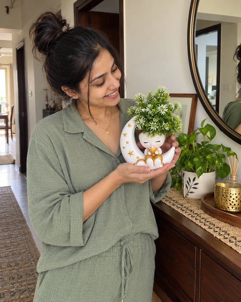 MiniKin Festival Moon Planter with its artificial plant beside a console table and mirror
