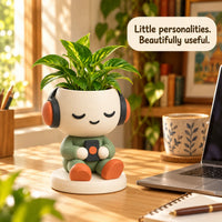Headphone Planter on a sunny desk beside a laptop
